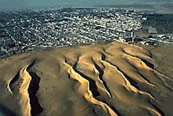 Desert sands creeping towards a town