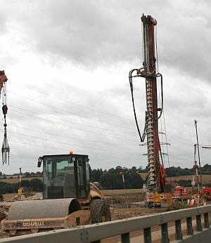 A drill to place foundations down through the soil into the firm ground below. Motorway carriageway widening, M1, Bedfordshire.